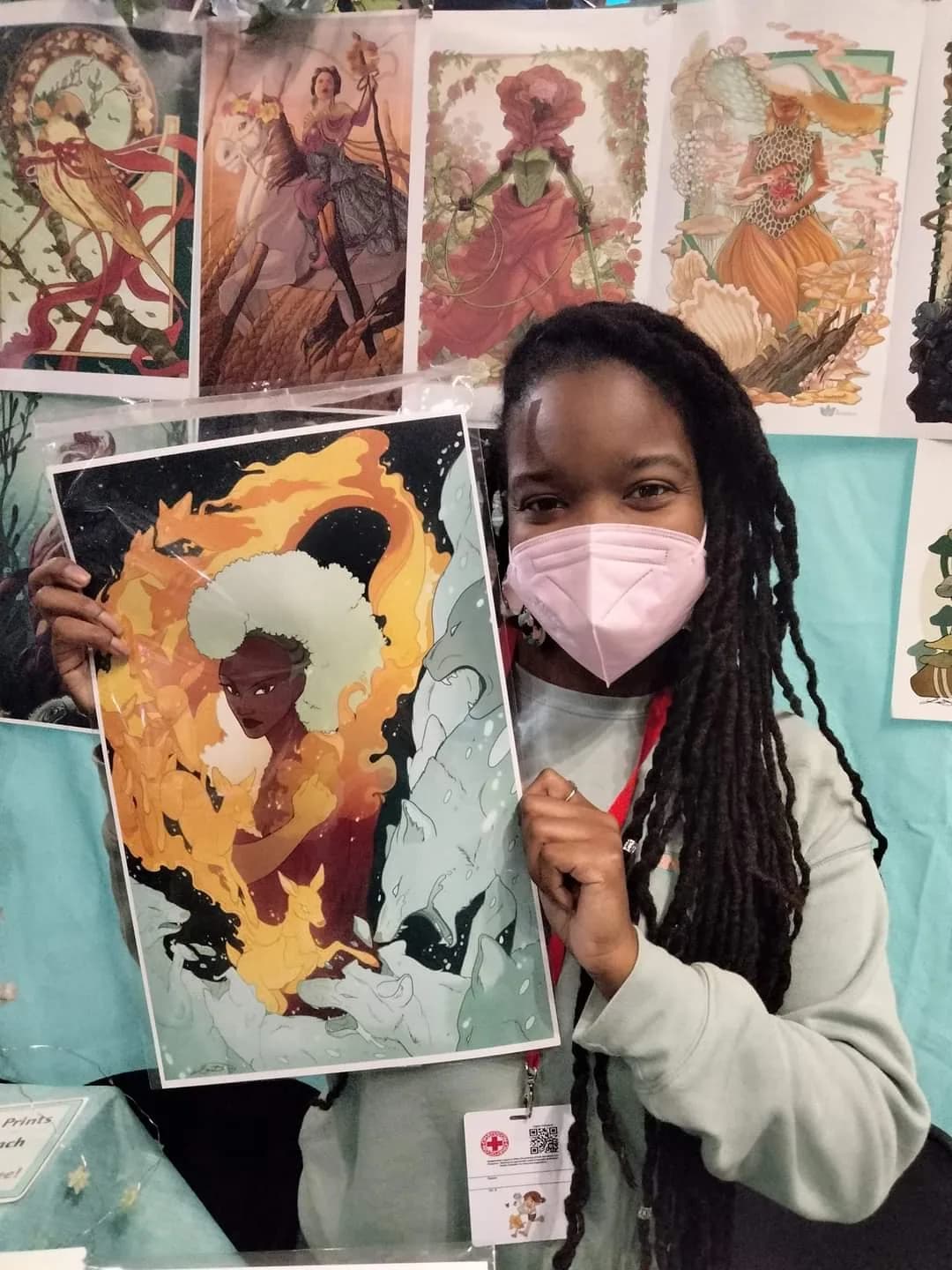 An artist holding a fantasy character print donated for a past Matsuricon charity auction