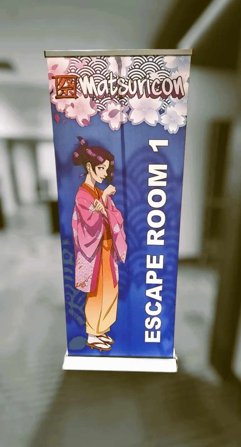A Matsuricon Escape Room banner standing in a convention hallway.