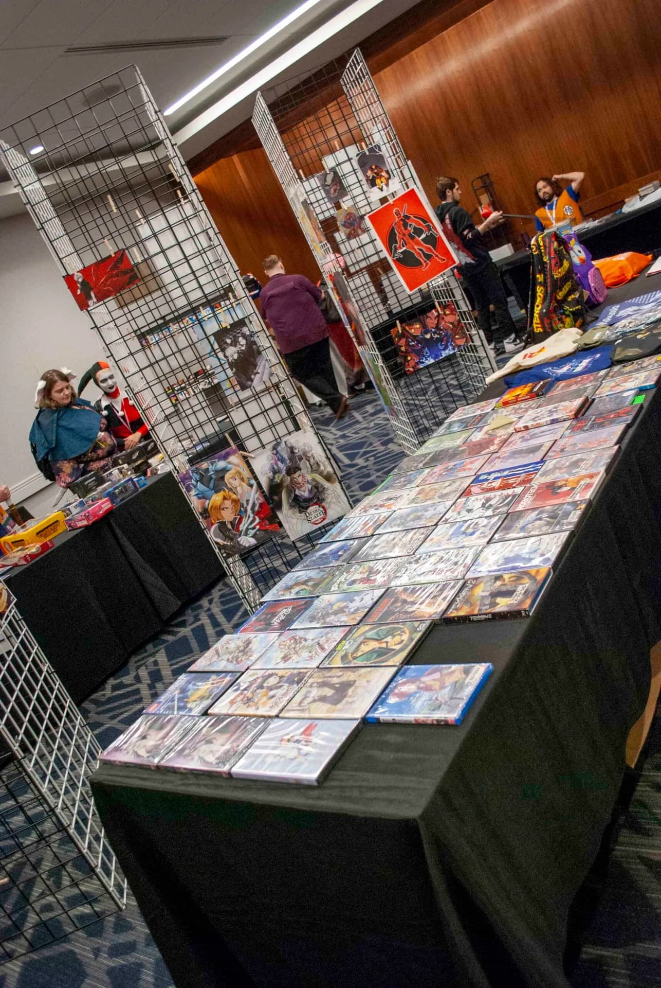 A Matsuricon charity auction room with tables and racks full of donated art and collectibles