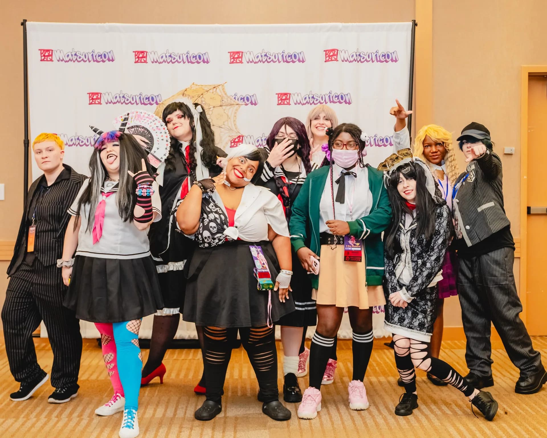 Cosplayers sharing a playful pose at a Matsuricon group shoot.