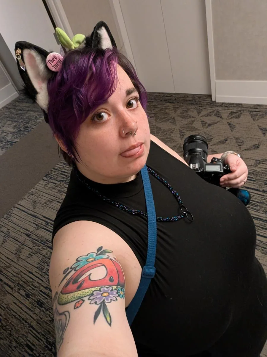 Portrait of Melissa Sterling holding a camera.